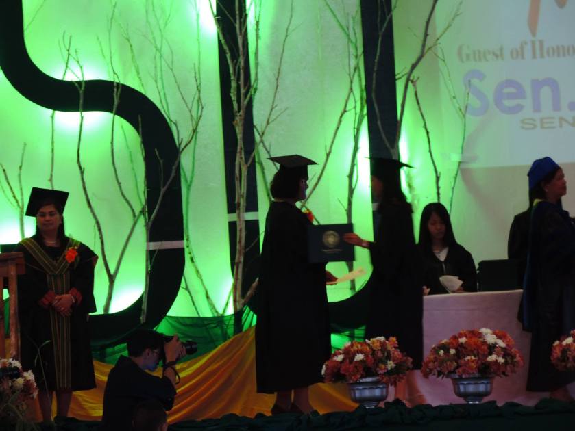 JUDITH AWARDING CERTIFICATE TO FREDALYN BASTIAN ONSTAGE